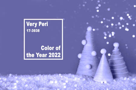 Trendy Color of year 2022. Diy Christmas trees is made of violet yarn on violet background