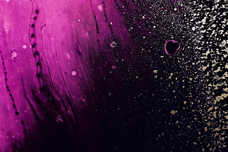 Fluid Art. Golden spray particles and purple waves on black background. Marble effect background or textureの写真素材