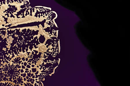 Fluid Art. Metallic gold abstraction on purple waves. Marble effect background or textureの写真素材
