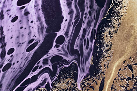 Fluid Art. Metallic gold abstraction and black purple waves. Marble effect background or textureの写真素材