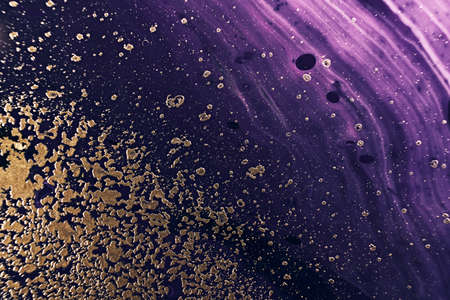 Fluid Art. Metallic gold particles and black purple waves. Marble effect background or textureの写真素材