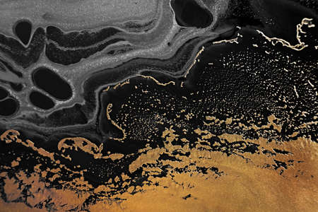 Fluid Art. Metallic gold and gray abstract waves. Marble effect background or texture