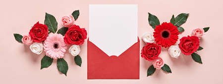 Red envelope with Romantic love letter mockup and flowers on pink Bannerの写真素材