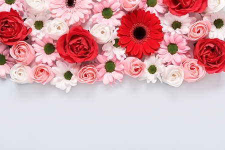 Floral composition of roses and gerberas on grey background. Arrangement of beautiful flowersの写真素材