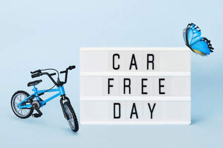 Car free day concept. Light box with Car free day text bicycle and butterfly. World bicycle dayの写真素材