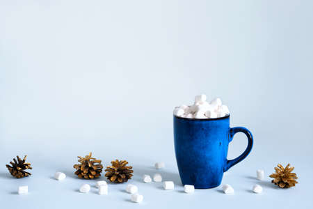 Christmas or New Year concept. Blue mug of cocoa with marshmallows and golden numbers, copy spaceの写真素材