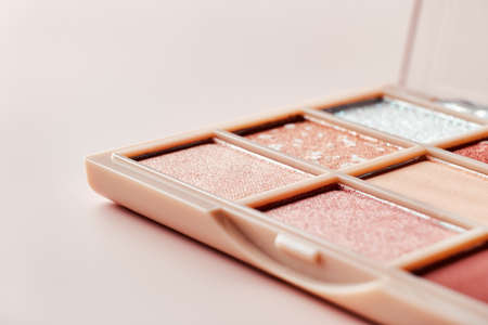 Eyeshadow colorful shades palette in beige tones close-up. Beauty abstract backgroundの写真素材