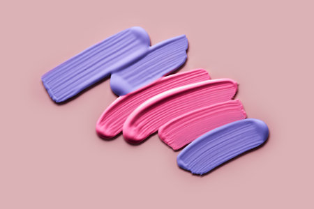 Pink and violet eye shadows Samples on pink background. Swatches of cream makeup strokesの写真素材