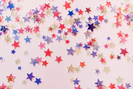 Red and blue Stars Glitter Confetti on pink background. Festive backdropの写真素材