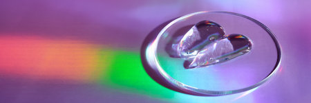 Smear of gel cosmetics product in petri dish on holographic banner with iridescent highlights.の写真素材