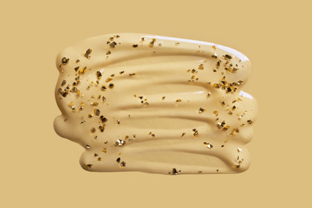 Liquid cosmetic gel swatch with gold particles on beige background. Anti-Aging Serum Sampleの写真素材