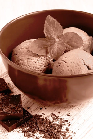 Chocolate ice cream decorated mint leaf tinted in mocha mousse colorの写真素材