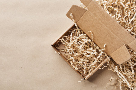 Eco-friendly shipping packaging on brown paper background, copy spaceの写真素材