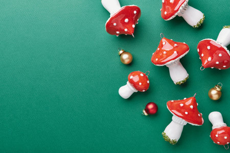 Ceramic amanita mushroom ornaments on teal green textured surface, copy spaceの写真素材