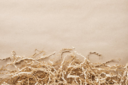 Kraft paper background featuring natural shredded packaging filler providing copy spaceの写真素材