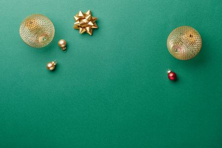 Golden baubles and bow creating festive christmas and new year holiday flat layの写真素材