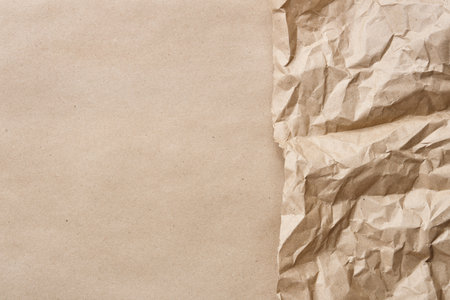 Crumpled brown kraft paper with smooth paper backgroundの写真素材