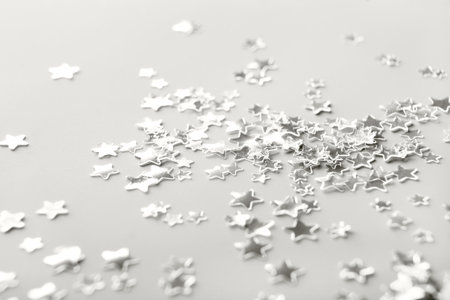Silver star-shaped confetti creating festive background. Color of the Year conceptの写真素材