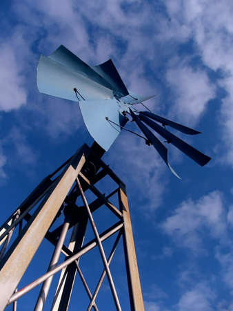 The sun was shining on this decorative windmill in autumn.  The sky was a perfect blue with fluffy white clouds floating above.の写真素材