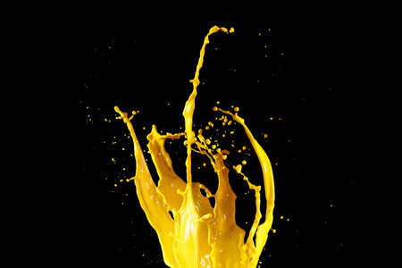 Yellow paint splash isolated on black backgroundの写真素材