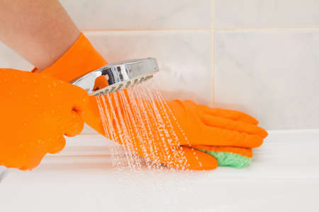 Housemaid cleaning a bathroom, closeup shotの写真素材