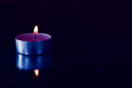 burning candle on a black backgroundの写真素材
