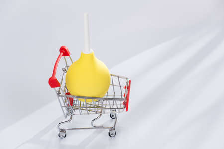 concept, enema in a supermarket trolley. Medicine and health.の写真素材