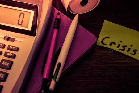 green sticker the Crisis lies on the Deskの写真素材