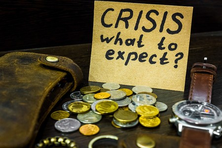 wallet and a sticker with the words crisis, what to expectの写真素材