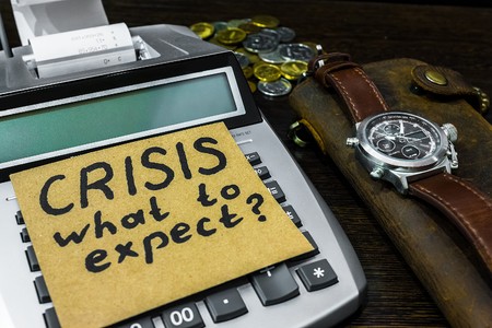 wallet and a sticker with the words crisis, what to expectの写真素材