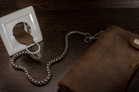 chain wallet is inserted in the socket with an electric currentの写真素材