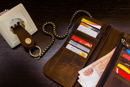 chain wallet is inserted in the socket with an electric currentの写真素材