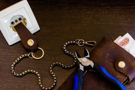 chain wallet is inserted in the socket with an electric currentの写真素材