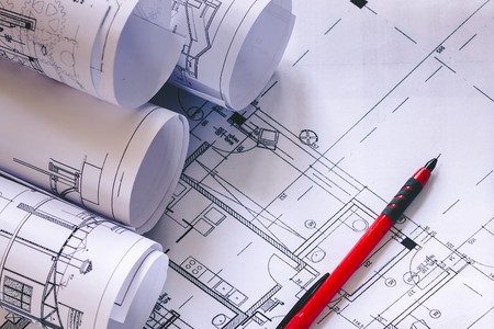 Measuring geodetic instruments and drawings are on the tableの写真素材