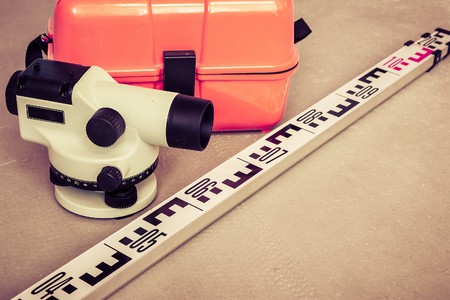 Measuring geodetic instruments and drawings are on the tableの写真素材