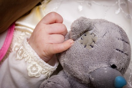 the baby hand touches first in your life Teddy bearの写真素材