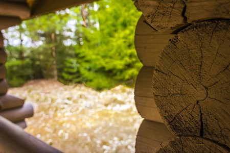 gazebo made of logs on the edge of the forest for recreation and picnic