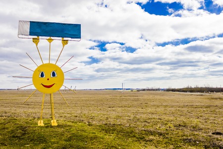 the iron monument to the sun in the field, happy spring, toned imageの写真素材