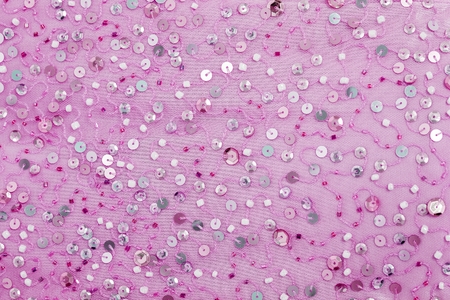 Background - texture festive designer fabric embroidered with colored sequins and beadsの写真素材