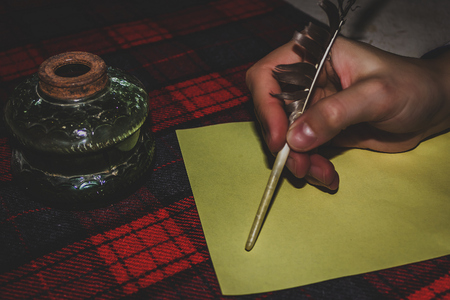 pen with inkpot standing on the table in anticipation of the authorの写真素材