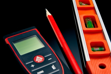 Optical level, laser range finder and a pencil lying on the floor to check