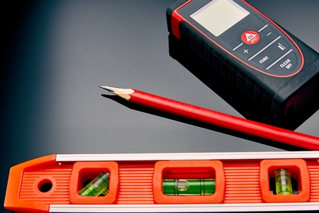 Optical level, laser range finder and a pencil lying on the floor to check
