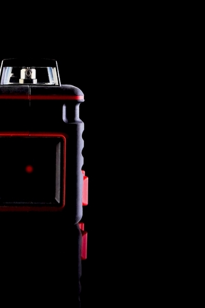 Modern laser level and special glasses are on the table on a black background. Can be used as a background image.の写真素材