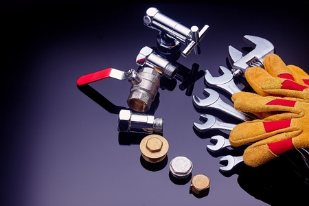 Set plumbing and tools on a green background. The fit, adjustable wrench for plumbing pipes and fittingsの写真素材