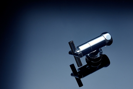 Plumbing accessories and tools on a dark background photographed close-upの写真素材