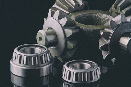 Gears, bearings and differential stars lie on the table close-upの写真素材