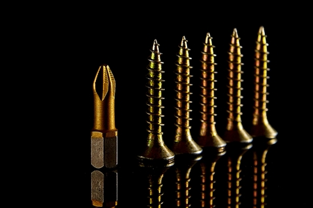 Screwdriver head, close-up bit, selective focus. blurred dark backgroundの写真素材