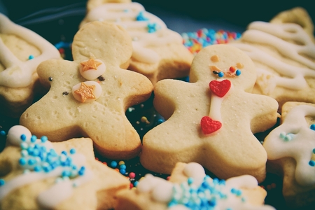 Plate with tasty Christmas cookies on wooden table