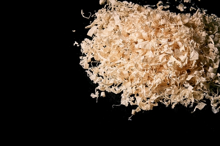 wood shavings on black glass with reflection. Can be used as backgroundの写真素材