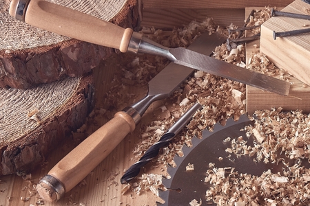 Shaving plane wooden shavings hammer flat chisels construction concept.